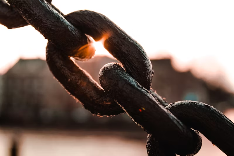 Close up of large linked chain with sun